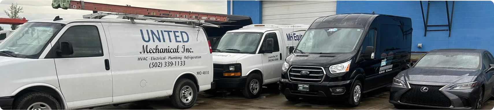 a group of white vans parked in a parking lot
